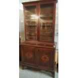 Late 19th/early 20th Century mahogany two stage cabinet back glazed bookcase, the interior revealing