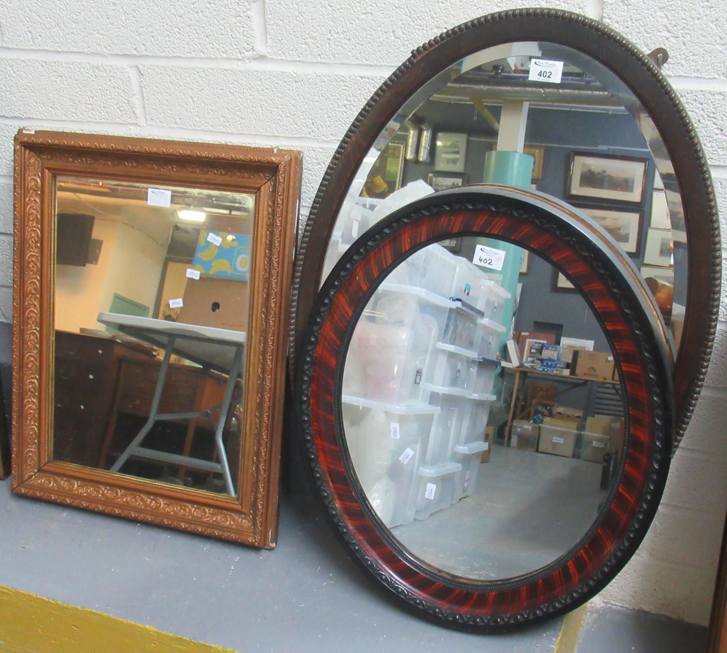 Early 20th Century oak framed and beaded bevel plate mirror. Together with another oval mirror