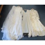 Two vintage 70's wedding dresses with lace detailing, high collars and long sleeves, one with a veil