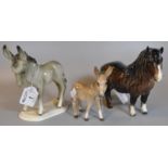 Two Beswick pottery donkey figurines, together with a West Germany 2840 donkey on naturalistic base.