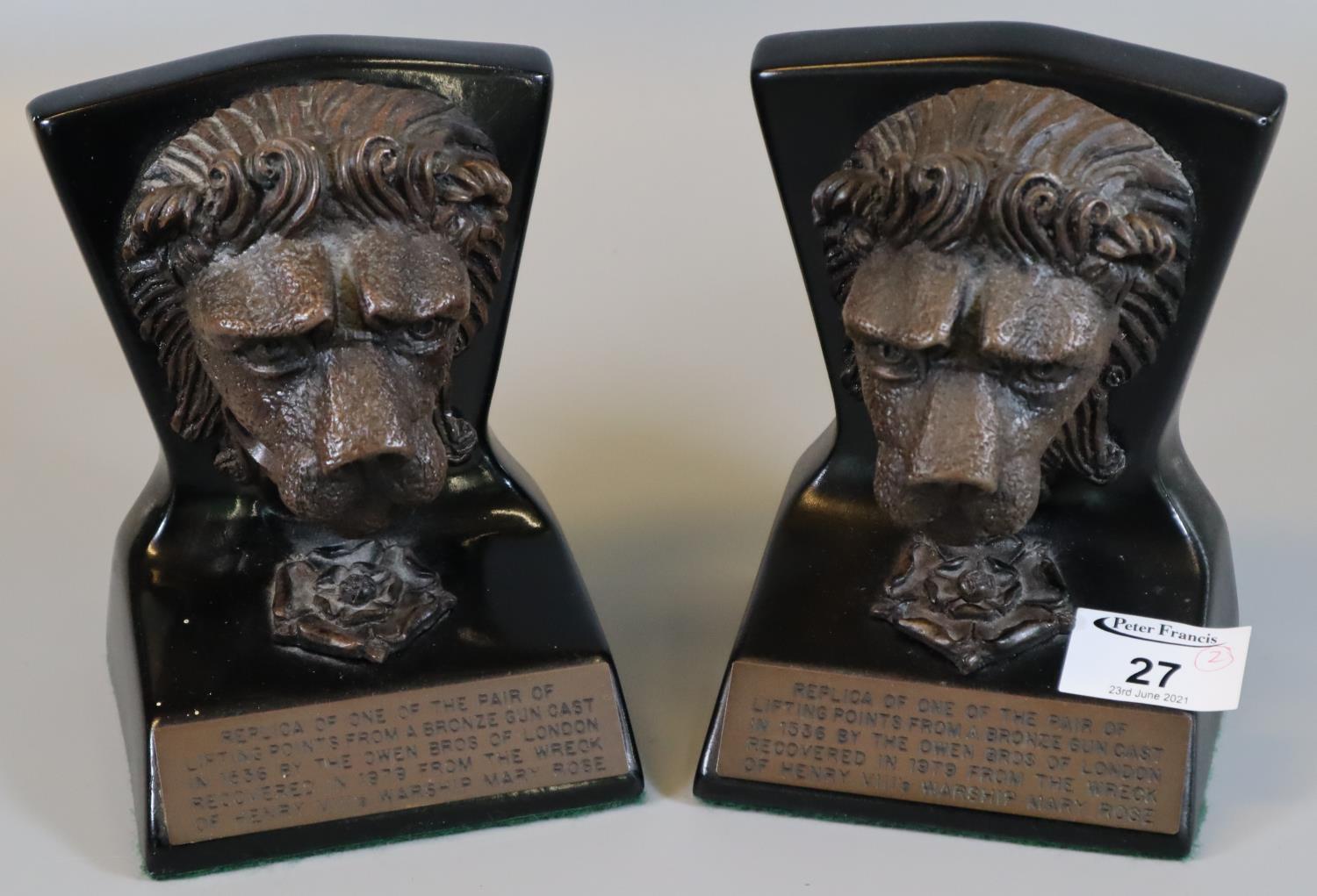 A pair of replica bookends in the form of mask head lions, one of a pair of lifting points from a