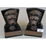 A pair of replica bookends in the form of mask head lions, one of a pair of lifting points from a