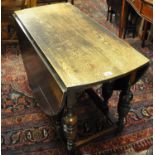 Early 20th Century oak gate legged table with vase supports. (B.P. 21% + VAT)