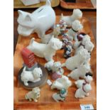 Collection of small ceramic West Highland terriers, together with a terrier money bank. (B.P.