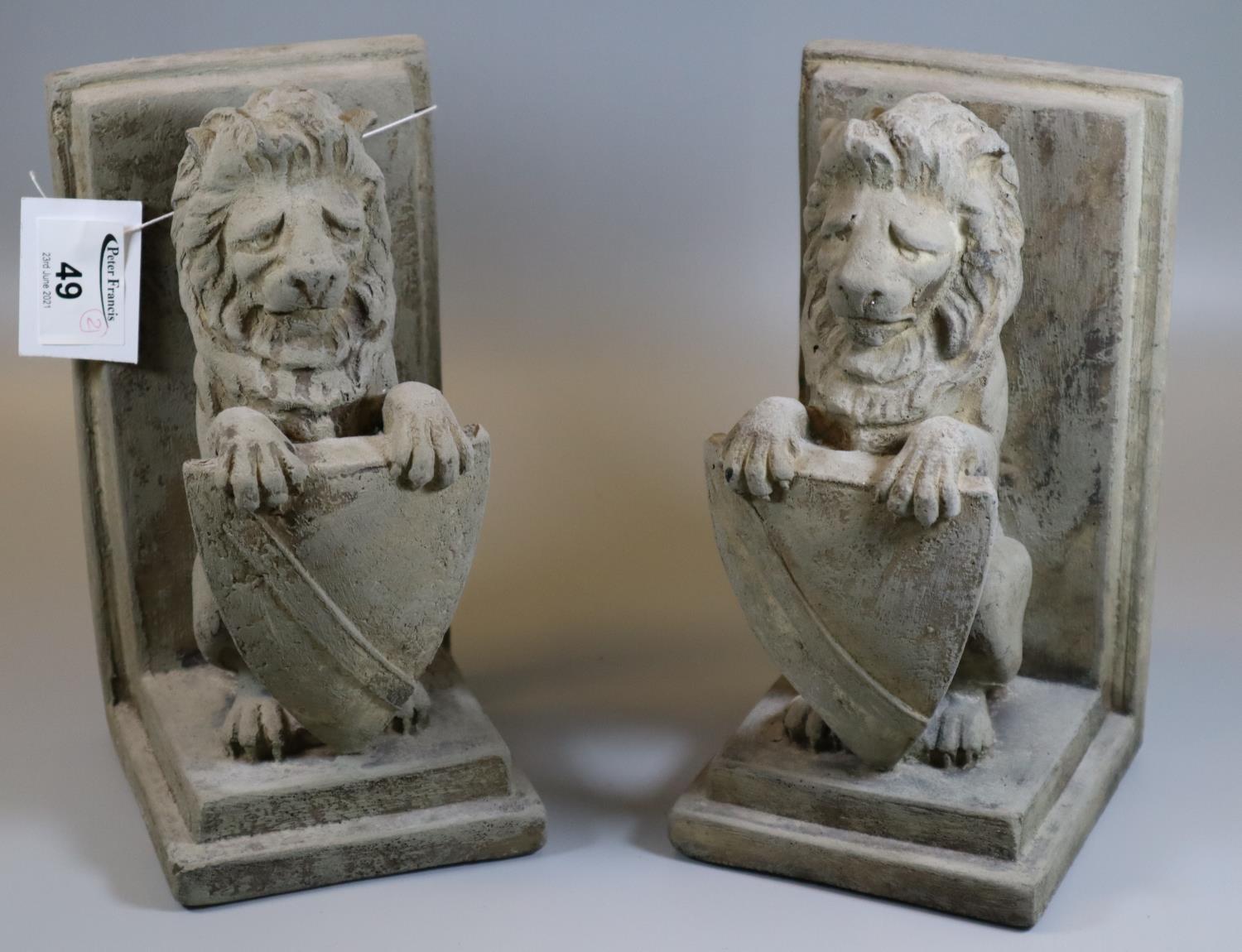 Pair of composite bookends in the form of seated lions with shields. (B.P. 21% + VAT)