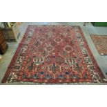 Vintage washed red ground Persian Baktia carpet with Persian panel design. 268 x 205cm approx. (B.P.