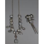 A silver and moonstone necklace and a white metal and moonstone brooch. (B.P. 21% + VAT)