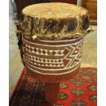 Tribal drum of circular form with hand painted geometric design on a pedestal base. (B.P. 21% + VAT)