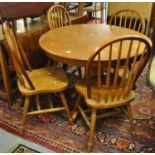 Modern oak centre or dining table on quatreform base, together with a set of four hoop and spindle