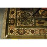 Modern Keshan carpet on a green and cream ground with foliate and floral panels. 415 x 300cm approx.