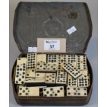 Art Nouveau metal tin, the interior revealing assorted bone dominoes. (B.P. 21% + VAT)