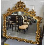 Modern gilt framed mirror having pierced and carved floral and foliate scroll decoration. (B.P.