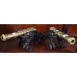 Pair of cast iron and brass cannons on stands with stylised mythical or dragon decoration. (B.P. 21%