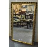 Small modern gilt framed bevel plate mirror having pierced foliate decoration. (B.P. 21% + VAT)