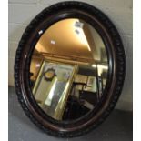 Edwardian oval mirror having moulded decoration. (B.P. 21% + VAT)
