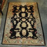 Navy and cream ground foliate design carpet. (B.P. 21% + VAT)