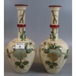 A pair of Victorian opaline glass baluster bud vases having painted floral and foliate designs. (B.