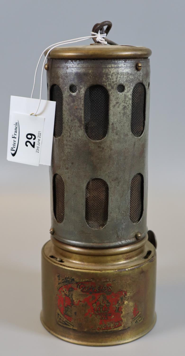 Early 20th Century brass and metal car heater with mesh grill, marked indistinctly with the