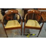 A pair of Edwardian mahogany inlaid curve back bedroom armchairs on tapering legs and pad feet. (