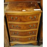 Reproduction yew wood serpentine narrow chest of four drawers. (B.P. 21% + VAT)