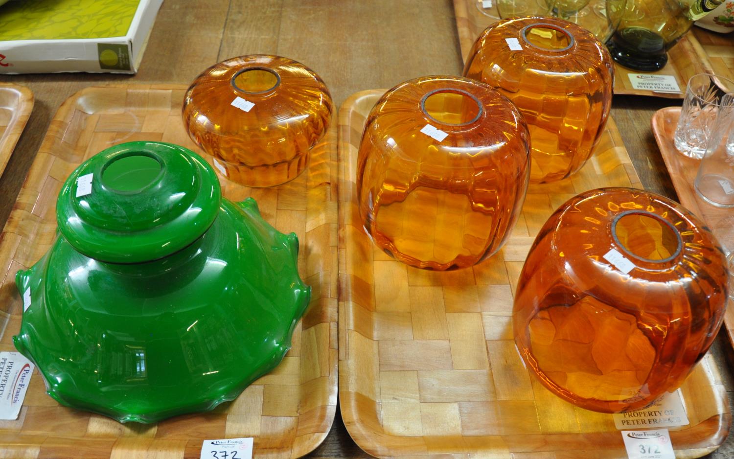 Four amber glass light shades and one green glass light shade. (5) (B.P. 21% + VAT) One of the amber