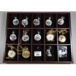 Collection of modern plated pocket watches with chains, some depicting locomotives in wooden display