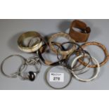 A collection of copper and costume jewellery bangles. (B.P. 21% + VAT)