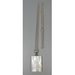 A white metal and mother of pearl pendant on a silver chain. (B.P. 21% + VAT)