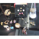 A collection of gold and yellow metal gemset earrings including a pair of ruby and diamond studs and