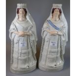 Two similar 19th century Staffordshire pottery large figures of Queen Victoria 'Queen of England,