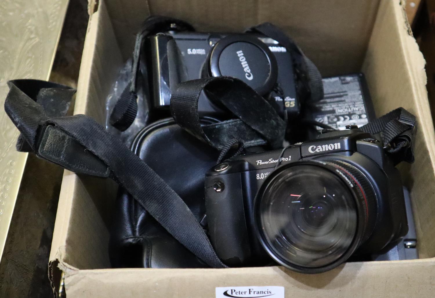Box of cameras and accessories to include Canon Powershot G5, Canon Powershot pro1, cables, etc. (