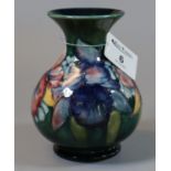 Moorcroft art pottery tube lined baluster shaped vase with coloured foliate decoration. Impressed