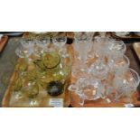 Two trays of glassware to include: six cut glass trifle bowls with stems, a tinted glass jug and