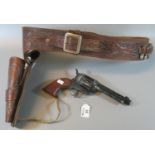 Facsimile diecast Colt cowboy revolver, together with a tooled leather holster and belt with