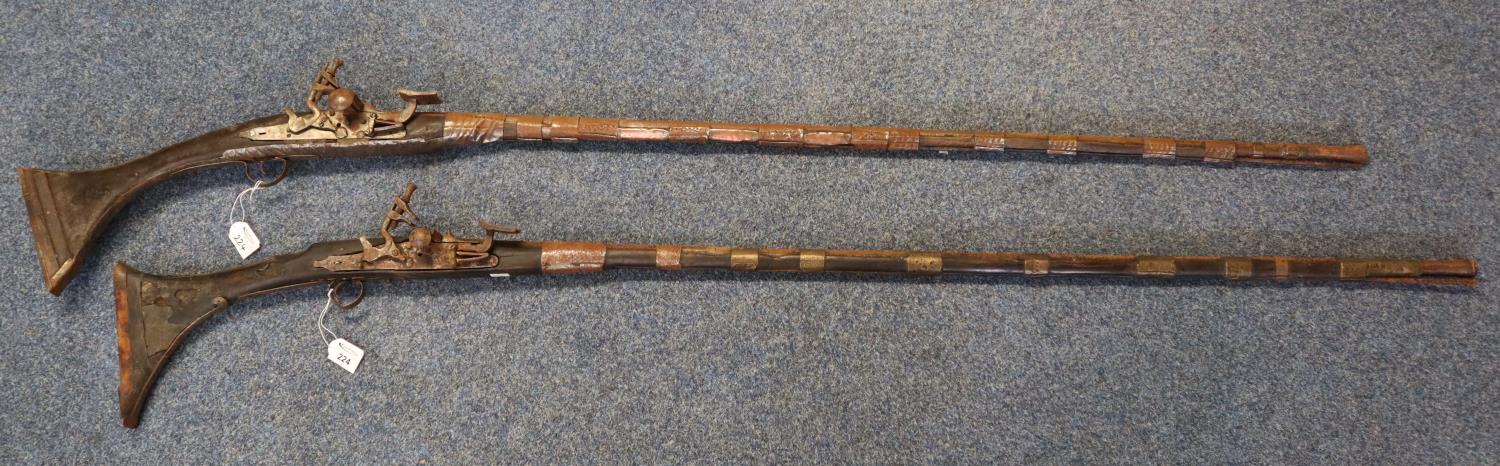 Two similar rustic Arab or Afghan type flintlock muzzle loading muskets. (2) (B.P. 21% + VAT)