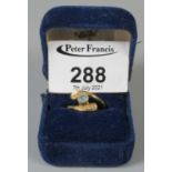 18ct gold aquamarine and diamond crossover ring. Ring size O. Approx weight 4.1 grams. (B.P. 21% +