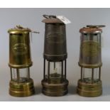 Three unused tradition brass minors safety lamps to include E. Thomas & Williams Ltd. of Aberdare,