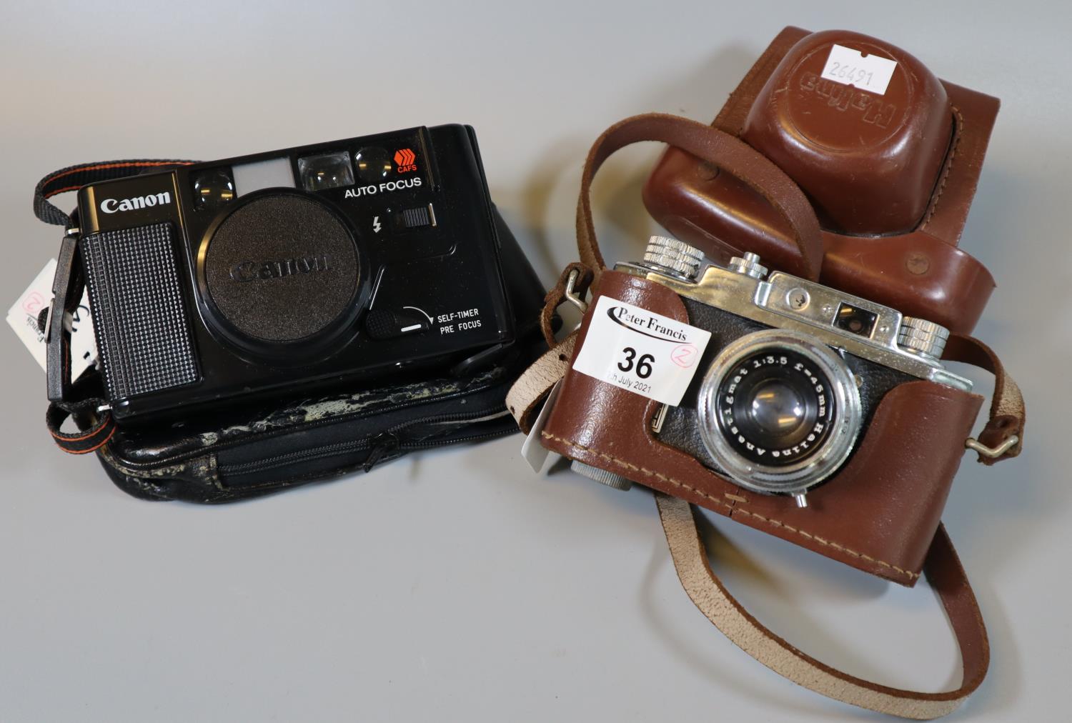 Halina 35mm view finder camera in every ready case, together with a Canon autofocus 35mm compact