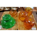Four amber glass light shades and one green glass light shade. (5) (B.P. 21% + VAT) One of the amber