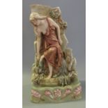 Royal Dux Art Nouveau porcelain spill holder modelled as a girl standing beside a waterfall, on