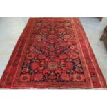 Blue and red ground Persian floral and foliate village rug. 167 x 240cm approx. (B.P. 21% + VAT)