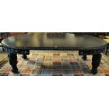 Late Victorian stained oak extending dining table with three additional leaves and winder. The