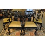 A set of fourteen ebonised Chippendale style dining chairs with drop in seats, all standing on