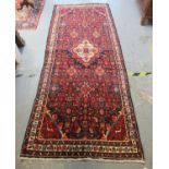 Full pile blue ground Persian Surok runner with multi-coloured petal borders, 288 x 116cm approx. (