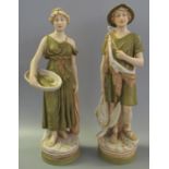 A pair of Royal Dux Art Nouveau porcelain figurines of a hunter and fish girl, shape no's 2122 and