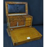 Early 20th Century oak stationery and writing cabinet opening to reveal letter compartments,