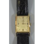 18ct gold Omega Deville rectangular faced quartz ladies wristwatch with baton numerals and leather