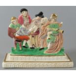 Dillwyn & Company Swansea porcelain flat backed figure group, coloured and gilded and depicting a