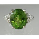Oval peridot and diamond ring set in 9ct white gold. Ring size M. Approx weight 5.8 grams. (B.P. 21%