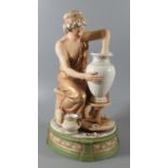 Royal Dux Art Nouveau porcelain figure of a lady potter with her vase and wheel sitting on a